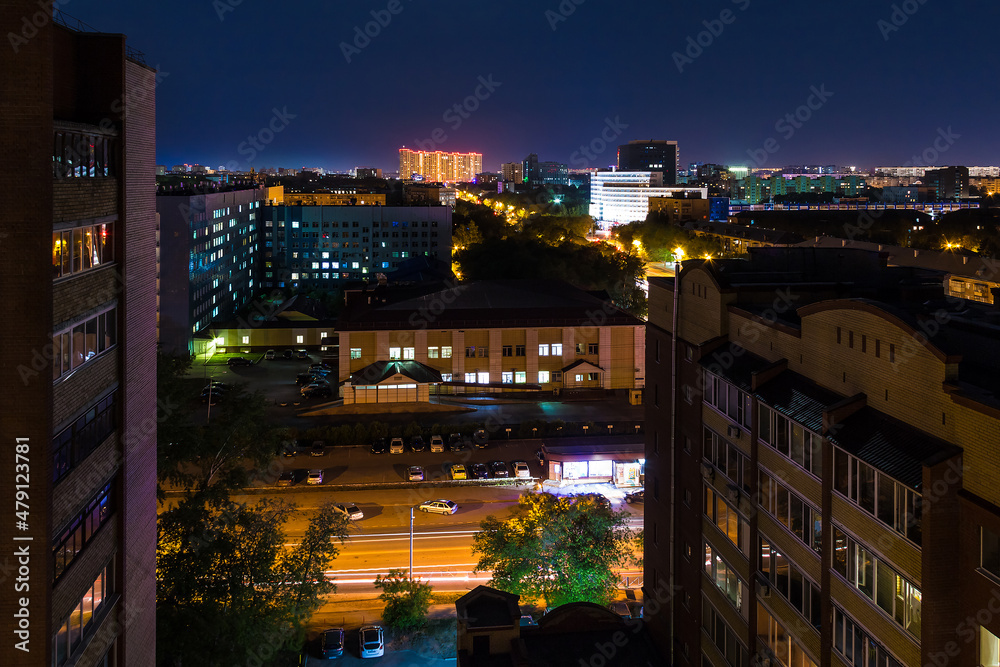 Beautiful aerial view of illuminated apartment buildings and the Regional Clinic Hospital №2 on the Harkovskaya Street in summer day at dusk, Tyumen, Russia
