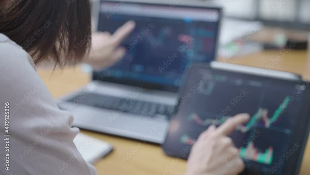 Young female investor looking at cryptocurrency chart going bullish on both laptop and tablet, time to get profit, all time high breaking resistance, high risk investing, green candle charts, new high Young female investor looking at cryptocurrency chart going bullish on both laptop and tablet, time to get profit, all time high breaking resistance, high risk investing, green candle charts, new high