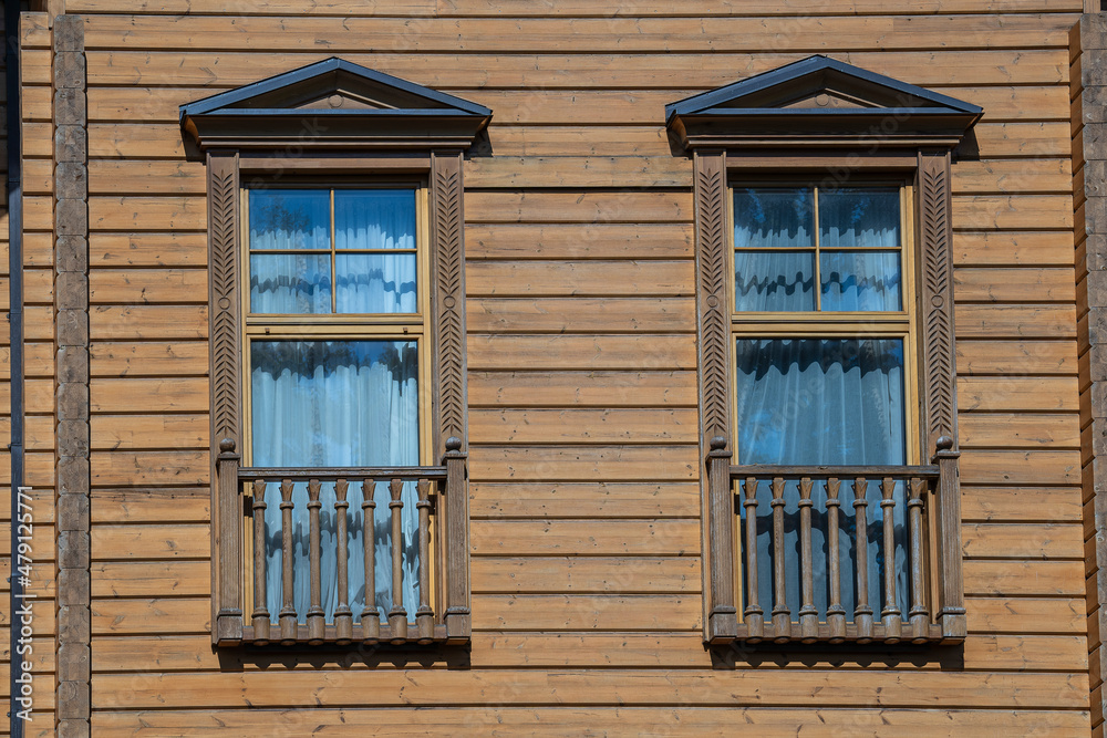 Detail of Ukrainian traditional rural wooden house, background exterior facade with windows frame. Ukraine