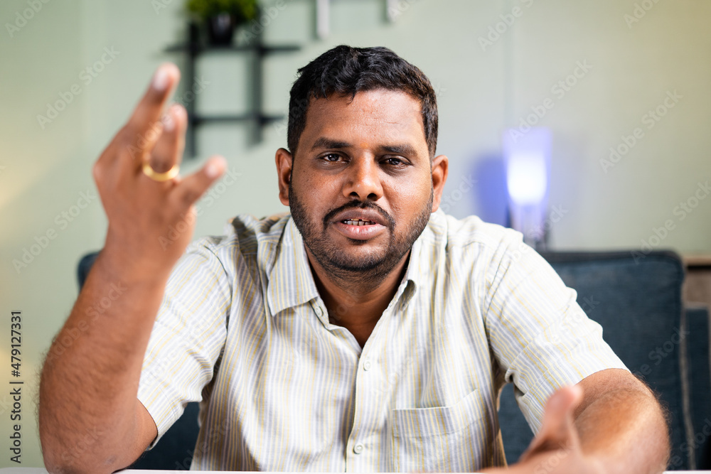 Fat man confidently explaining or talking by looking at camera on video call - concept of online video conference, meeting and webinar. Fat man confidently explaining or talking by looking at camera on video call - concept of online video conference, meeting and webinar.