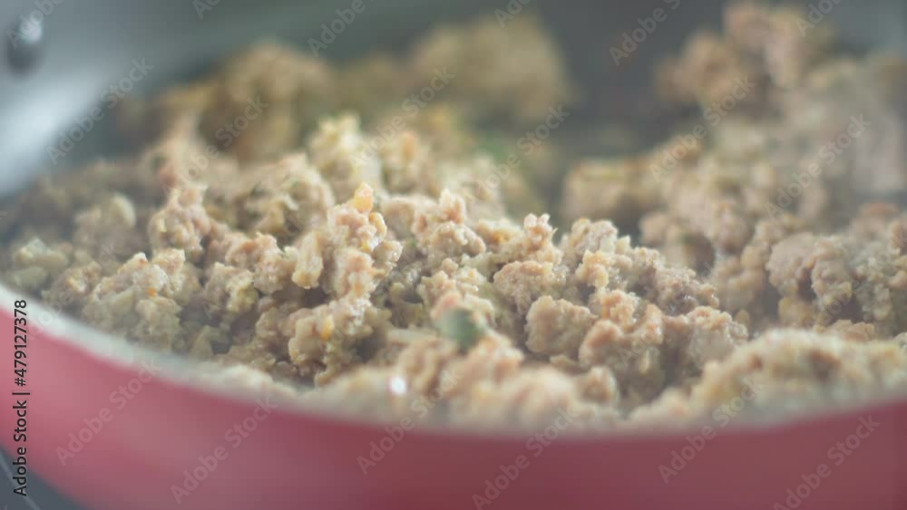 Appetizing homemade braising food, ground meat with onion, being prepared inside a pan Appetizing homemade braising food, ground meat with onion, being prepared inside a pan