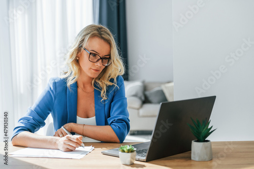 Woman in casual clothes is indoors at home