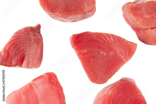 Yellow fin tuna steaks isolated on black background. Fresh rare tuna steaks isolated on black. Raw yellowfin tuna fillet texture. Background fresh tuna meat. Top view of slices of tuna meat.