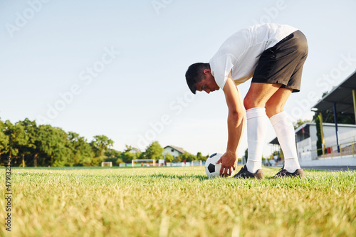 Preparing for the game. Young soccer player have training on the sportive field