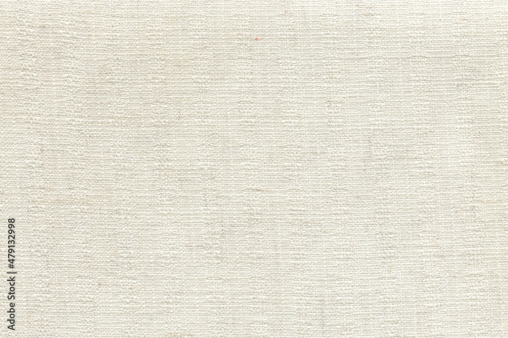 The texture of coarse linen natural fabric is white with a clear interweaving of threads. A soft napkin of a milky shade. The texture of coarse linen natural fabric is white with a clear interweaving of threads. A soft napkin of a milky shade.
