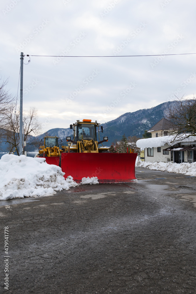In winter, a huge bulldozer is parked for snow removal. In winter, a huge bulldozer is parked for snow removal.