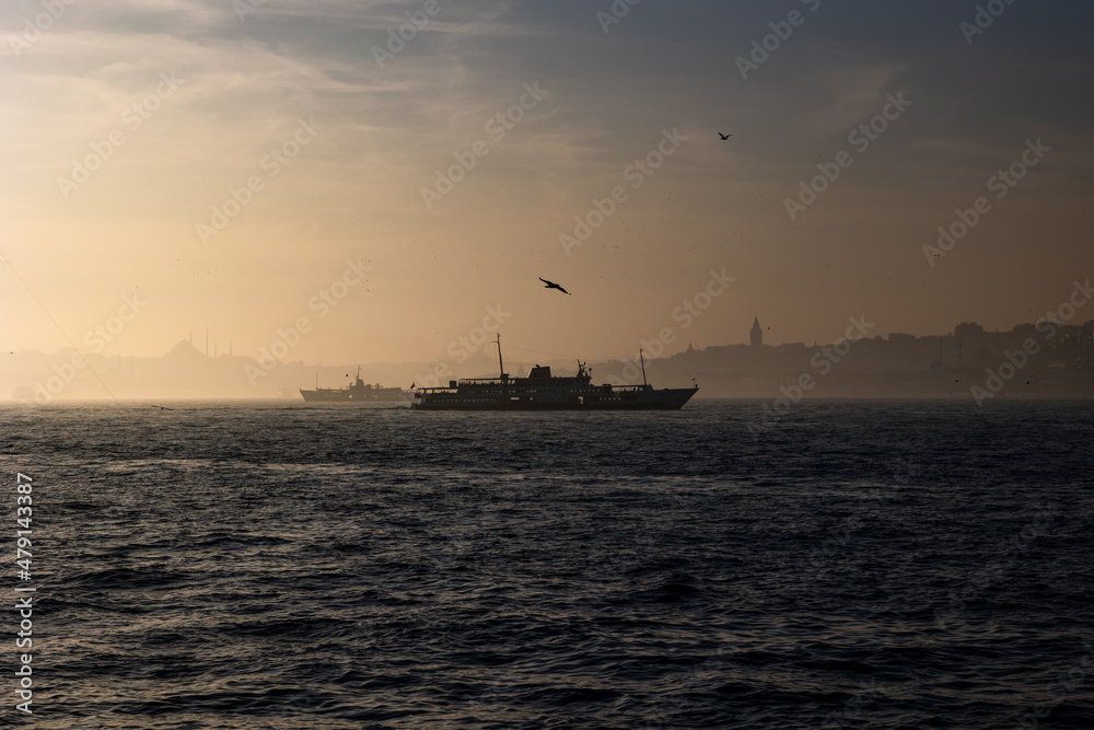 Moody Istanbul background. Silhouette of ferry and cityscape of Istanbul.