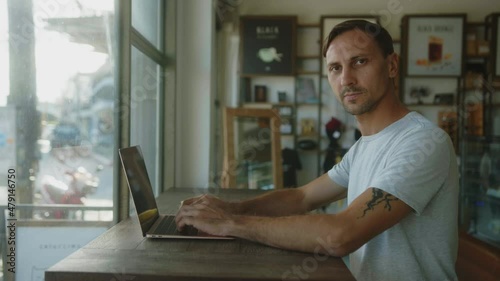 Digital Nomad works on a laptop in a coffee shop