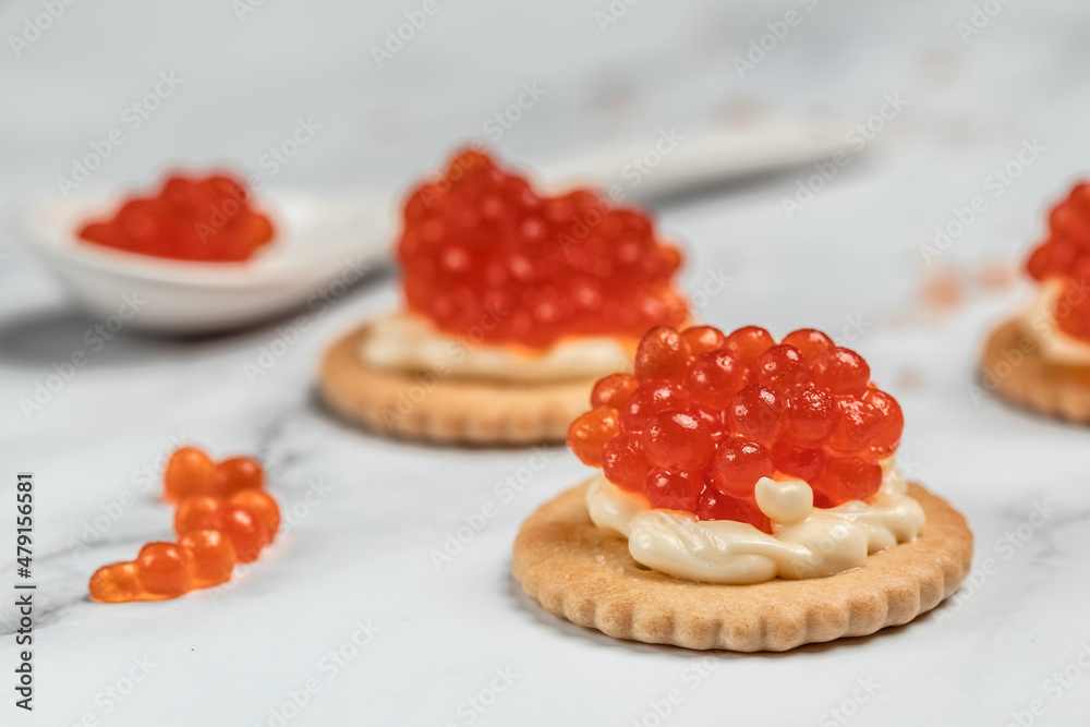 Canape portion cracker, butter and red caviar. Delicious red caviar appetizer, banner, menu, recipe. selective focus, place for text Canape portion cracker, butter and red caviar. Delicious red caviar appetizer, banner, menu, recipe. selective focus, place for text