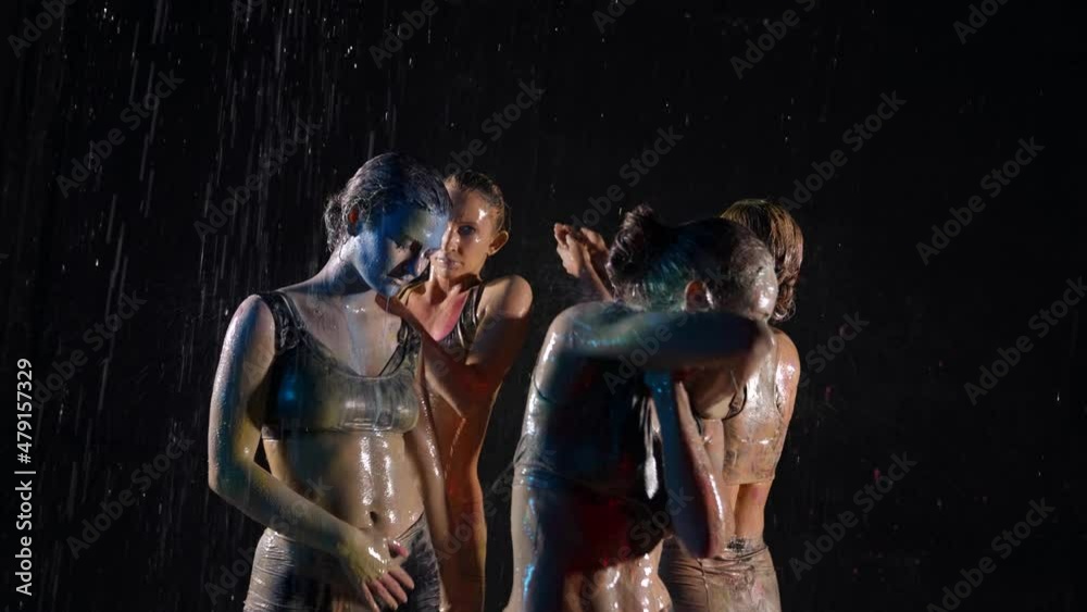 sexy ladies are dancing in rain in night, washing off paints from bodies, dancers in water flows sexy ladies are dancing in rain in night, washing off paints from bodies, dancers in water flows
