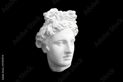 bust head of a woman made of plaster cast isolated on black background. three-quarter position