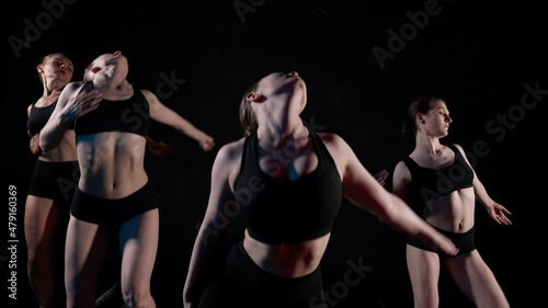 young sexy ladies are dancing sensual modern dance in darkness, slow motion shot