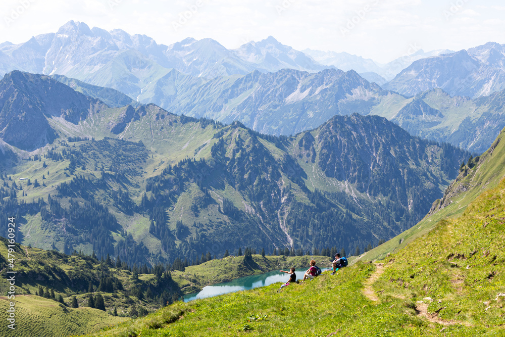 Wanderer machen in den Alpen Bergen Pause und genießen die Landschaft 