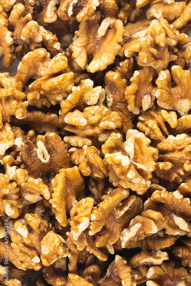 Peeled fresh golden walnuts close up in bulk top view Peeled fresh golden walnuts close up in bulk top view
