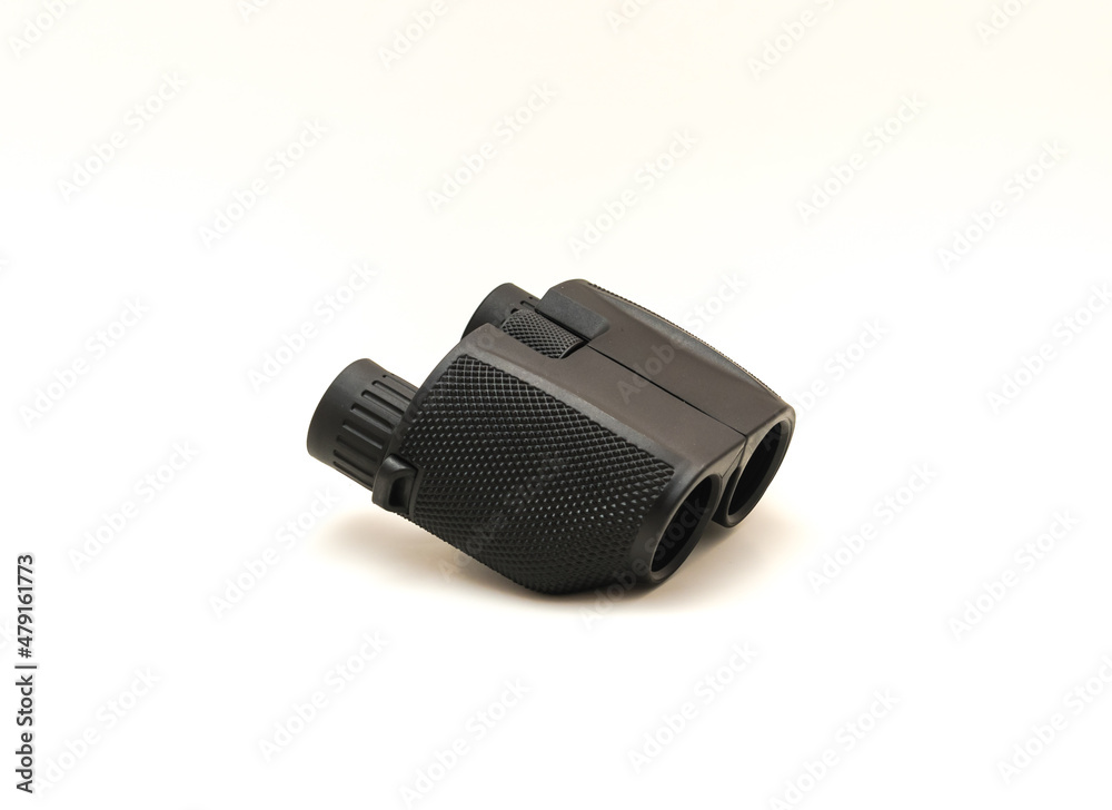 Side view a black compact Binoculars with rubber armor ergonomic steady grip isolated on white Side view a black compact Binoculars with rubber armor ergonomic steady grip isolated on white