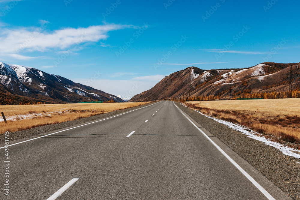 A road in the mountains with beautiful landscapes and views of rocks and peaks in Altai