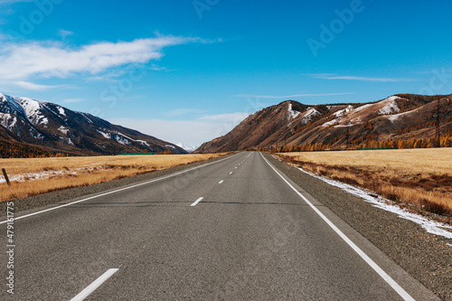 A road in the mountains with beautiful landscapes and views of rocks and peaks in Altai