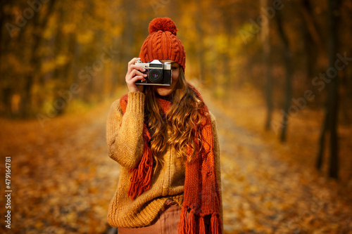 Woman with retro camera in autumn park