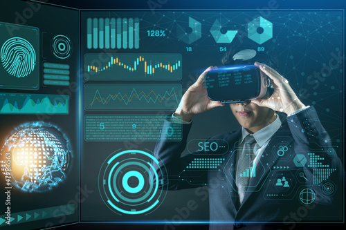 Technology and digital business innovation concept, Businessman wearing glasses of virtual reality goggles at night with soft blur bokeh