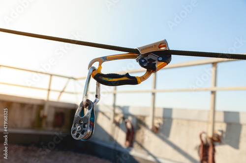 Descent device in the rays of the sun on the roof, equipment for high-rise work.