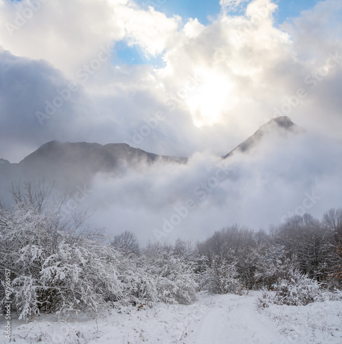 mountain valley in snow at the pale sunny day, winter outdoor travel scene