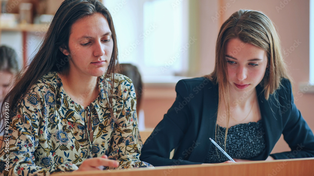 Pupils of the 11th grade in the class at the desks during the lesson. Russian school.