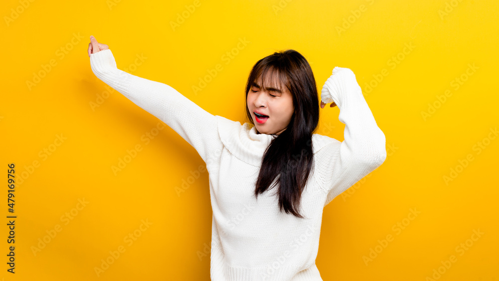 Asian woman sleepy after hard work Workers' sleep problems on a yellow background Asian woman sleepy after hard work Workers' sleep problems on a yellow background