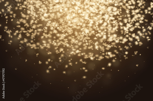 Abstract stylish light effect on a dark background. Gold luminous dust and glare. Flash Light
