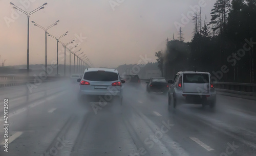 Traffic in heavy rain on highway. © Yuri Bizgaimer