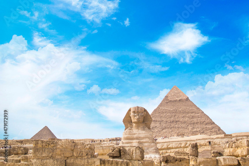 Great Sphinx against the background of the pyramids of the pharaohs Cheops  Khafren  and Mikerin in Giza  Egypt