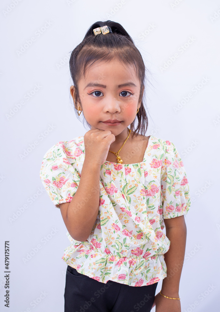 Cute asian little girl with her fashion style clothes, posing in studio on white background. 