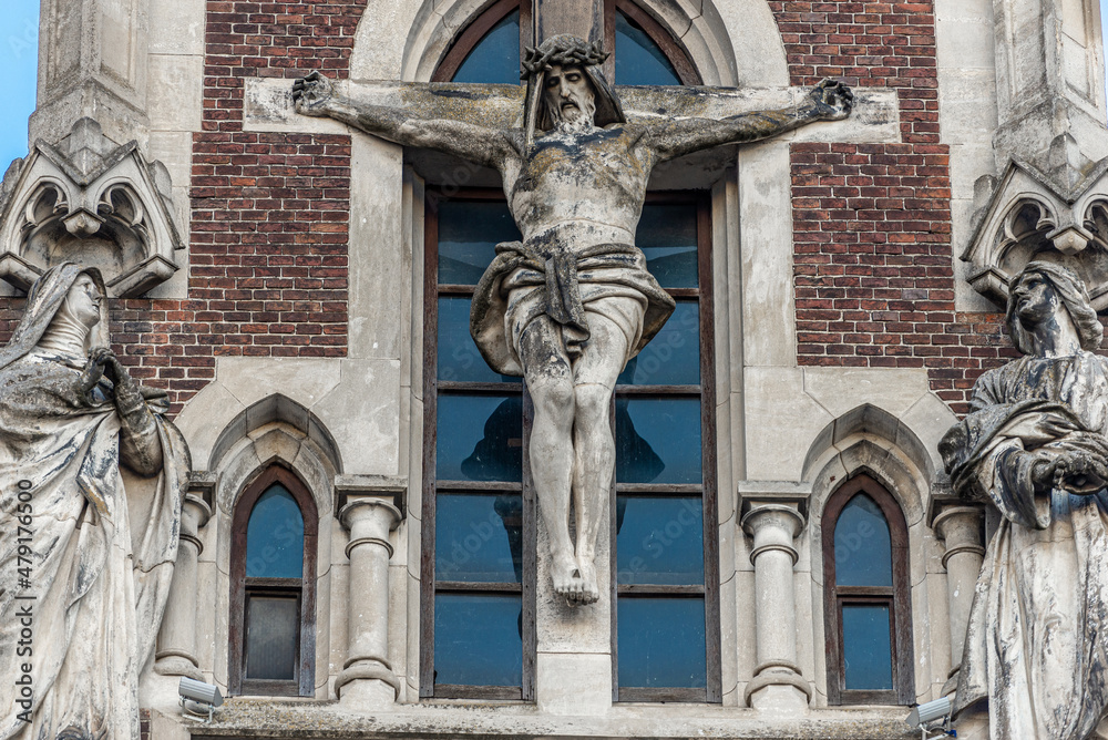 Obraz premium LVIV, UKRAINE - January, 2021: Exterior of the Greek Catholic Church of Sts. Olha and Elizabeth. Statue of Jesus Christ crucifixion on facade.