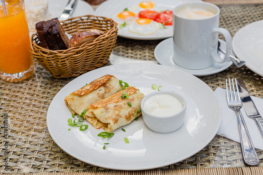 morning breakfast stuffed pancakes on a white plate, russian traditional food