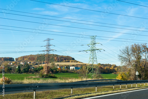 power poles on the background of fields and forests