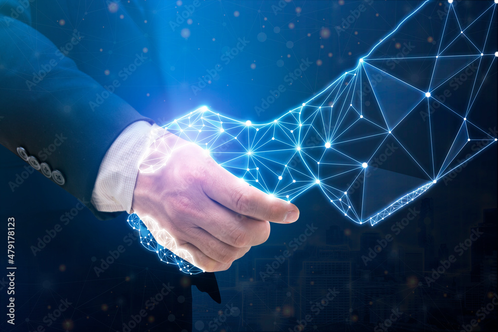 © jittawit.21 - Businessperson shaking hand with digital partner over futuristic background.