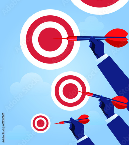 Hand holding darts of different sizes to shoot bullseye of different sizes, business concept illustration