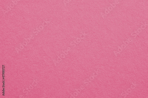 Pale red-violet cardboard surface. Paper texture with cellulose fibers. Light red background with a pastel tint. Paperboard wallpaper. Textured pacific pink backdrop. Macro