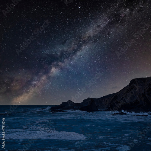 Digital composite image of Milky Way night sky over Stunning landscape image of view from Hartland Quay in Devon