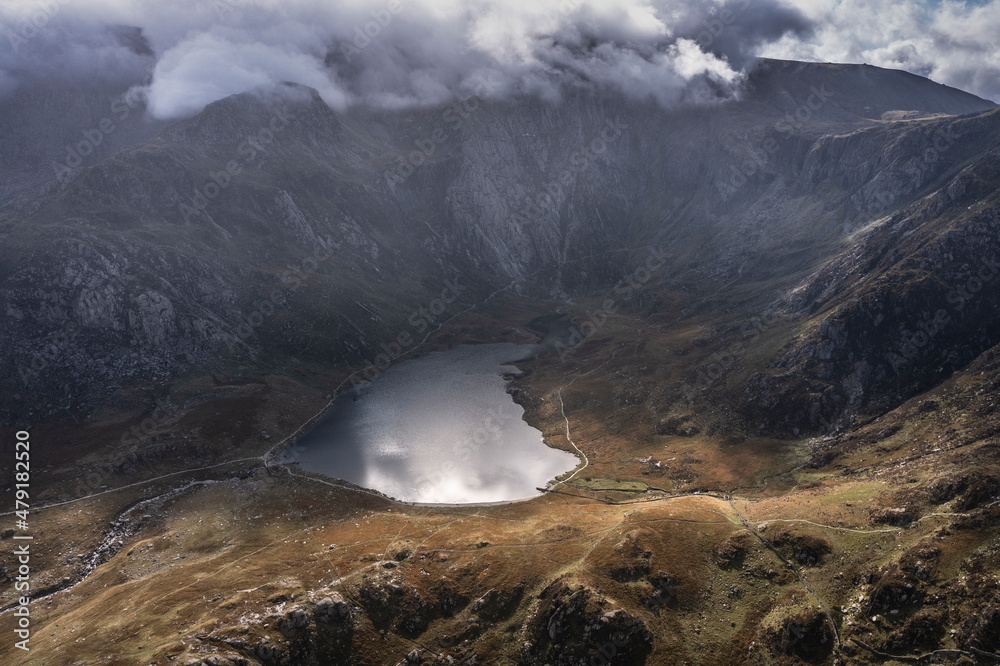 Aerial view of flying drone Epic dramatic Autumn landscape image of Llyn Idwal in Devil's Kitchen in Snowdonia National Park with gorgeous light Aerial view of flying drone Epic dramatic Autumn landscape image of Llyn Idwal in Devil's Kitchen in Snowdonia National Park with gorgeous light