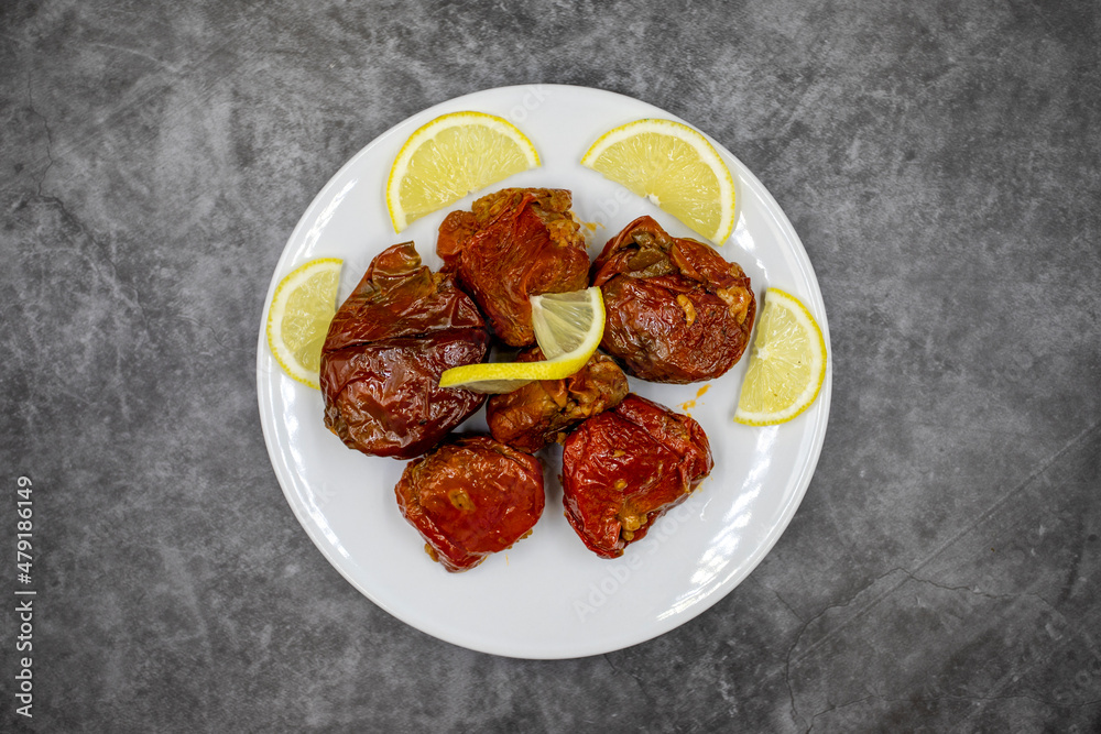 Dried stuffed peppers on a dark background. Rice stuffed sundried red pepper. Turkish cuisine appetizers. Kuru biber dolması. Top view. close up Dried stuffed peppers on a dark background. Rice stuffed sundried red pepper. Turkish cuisine appetizers. Kuru biber dolması. Top view. close up