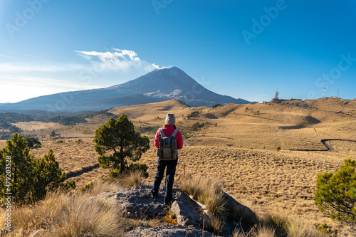 Mountaineer Walking On The Mountain with view at popocatepetl volcano