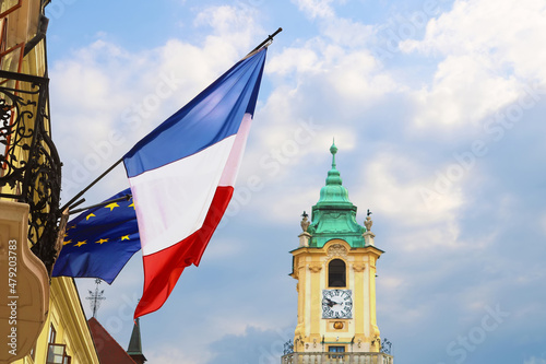 Flags of EU and France on the building of French centre (left) and city hall (centre), Bratislava, Slovakia