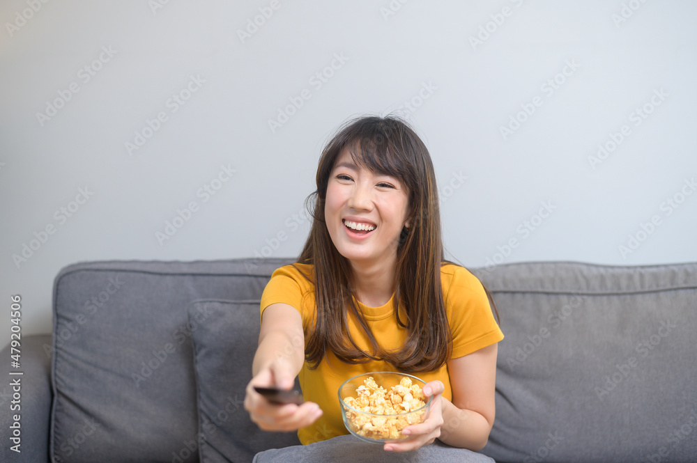 Young happy woman watching movie and relaxing at home Young happy woman watching movie and relaxing at home