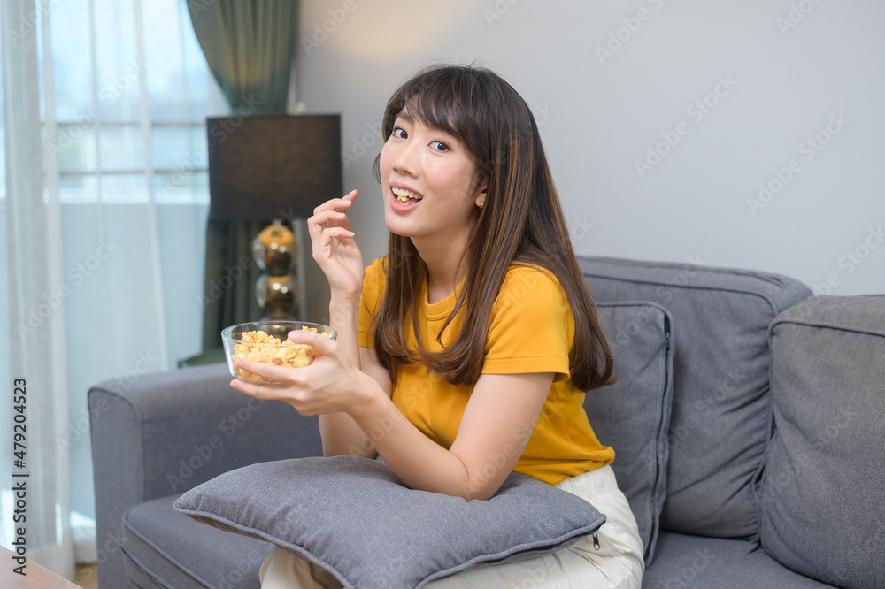 Young happy woman watching movie and relaxing at home Young happy woman watching movie and relaxing at home