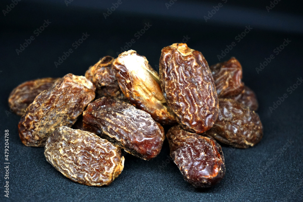 Obraz premium delicious dried dates with black background