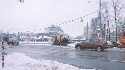 it's snowing. Moscow was covered with snow. Cars drive very slowly.