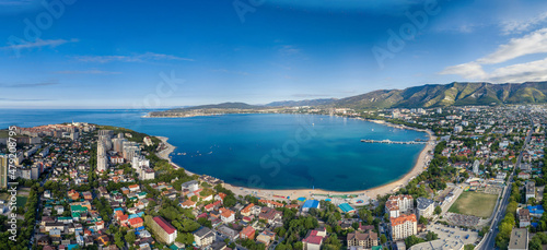 Panorama of the seaside resort on the shore of the sea bay. aerial view. Sea beaches along the bay, sanatoriums and boarding houses. a mountain range in the background