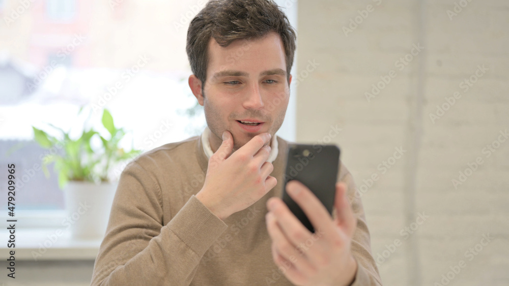 Man Talking Video Call on Smartphone in Office Man Talking Video Call on Smartphone in Office