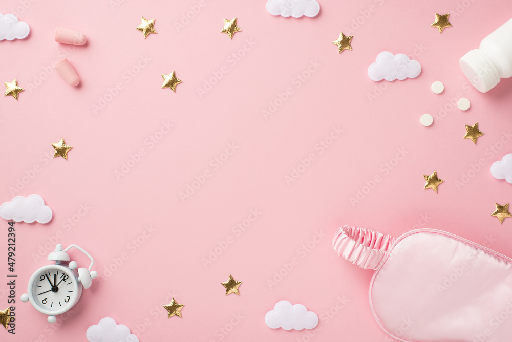 Top view photo of small white alarm clock pink silk sleeping mask earplugs bottle with pills golden stars and clouds on isolated pastel pink background with blank space in the middle