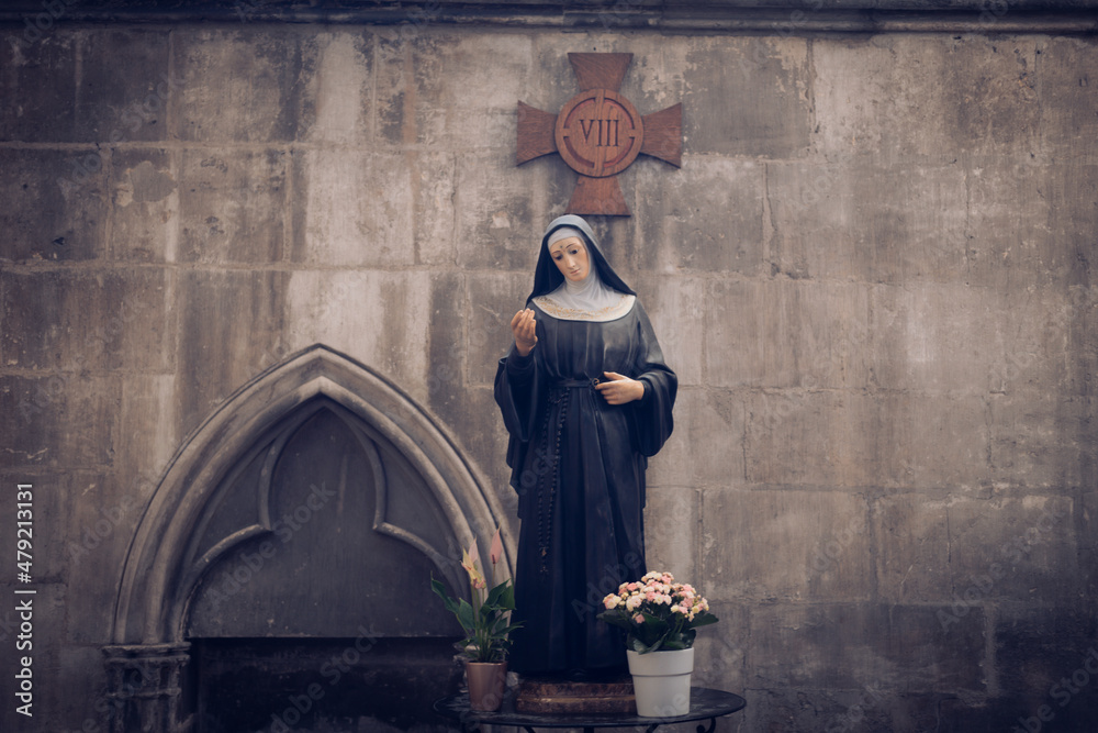 Statue of Nun on table in gothic church